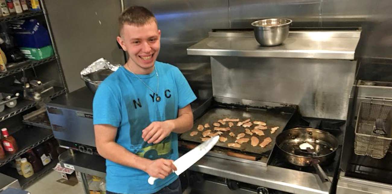 The chef in the kitchen at Pinheads Bowling in Oak Hill, West Virginia, prepares chicken on the grill for dinner.