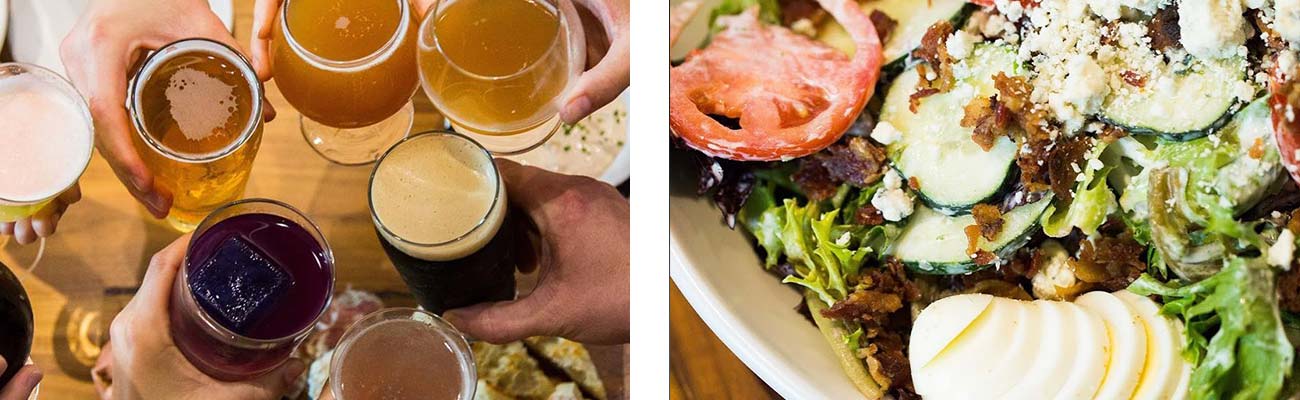 Friends toasting an assortment of beers in pint glasses with a salad from Secret Sandwich Society Fayetteville.