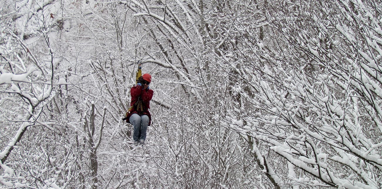 Winter zip lining after a fresh snowfall in the New River Gorge at ACE Adventure Resort in Oak Hill, WV.