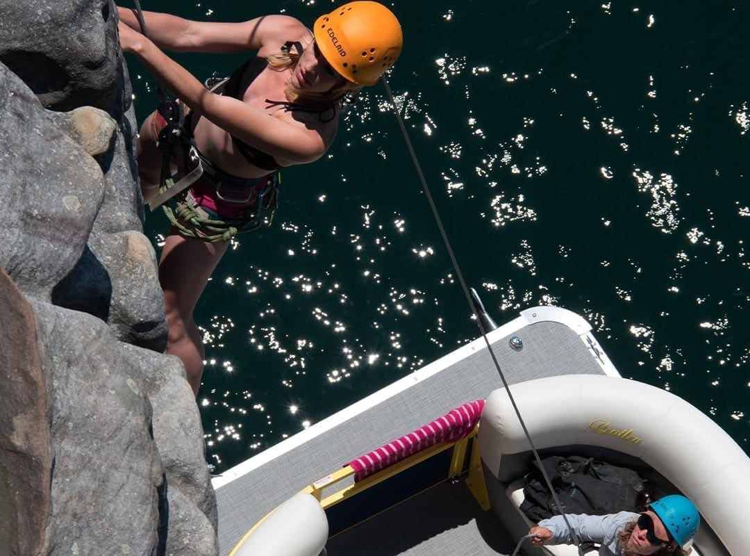 girl climbing above boat