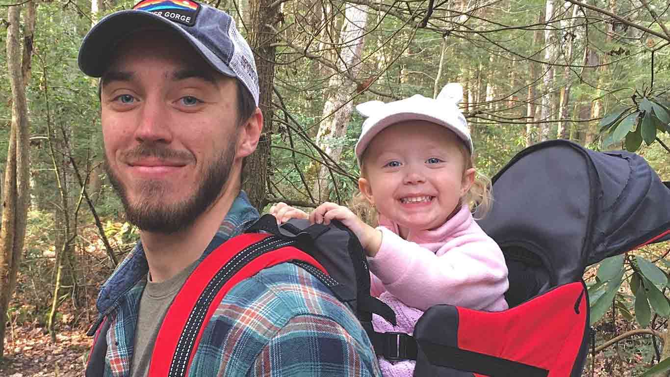Jake posing with his daughter on a trail