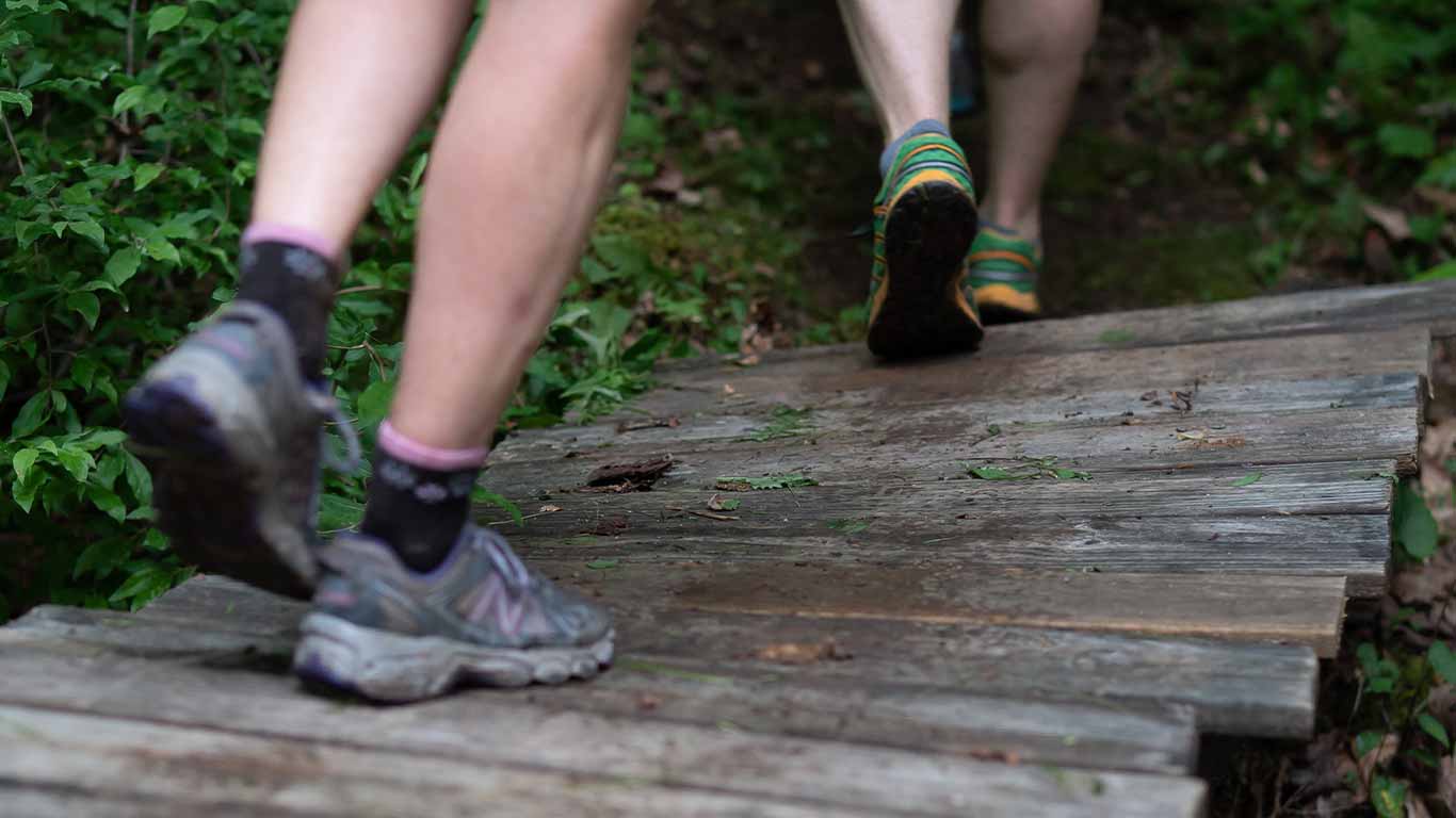 Trail runner's shoes on a bridge