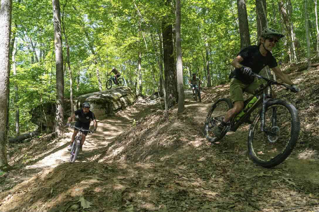 mountain bikers on trails in needleseye park in oak hill